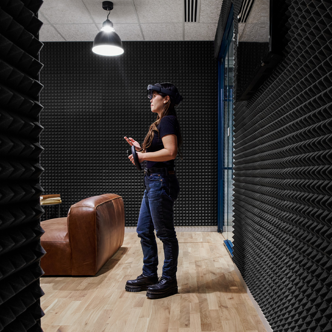 Woman with a VR headset on in a noise proof room