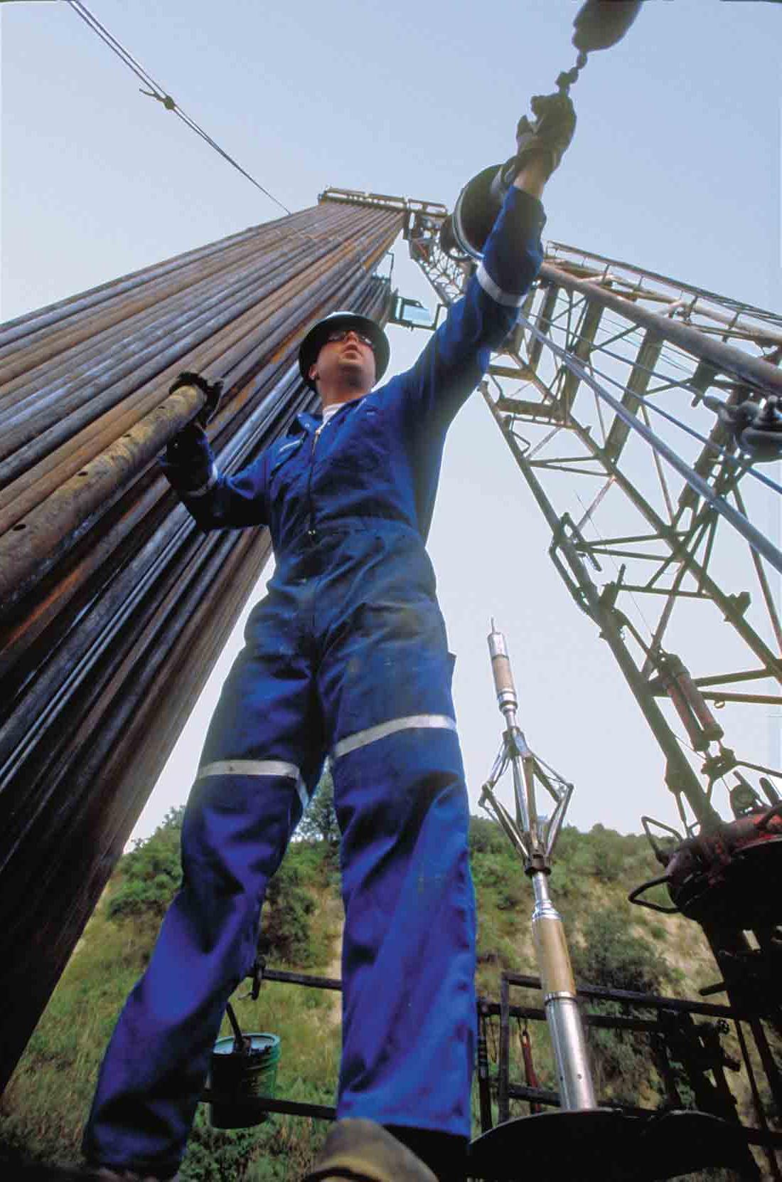 A Schlumberger employee preparing the PowerCutter to be lowered in a well.