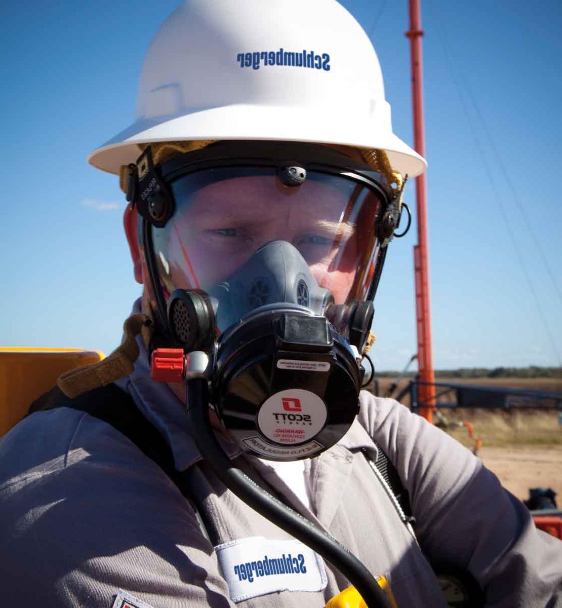 Worker in field wearing hydrogen sulfide mask protection