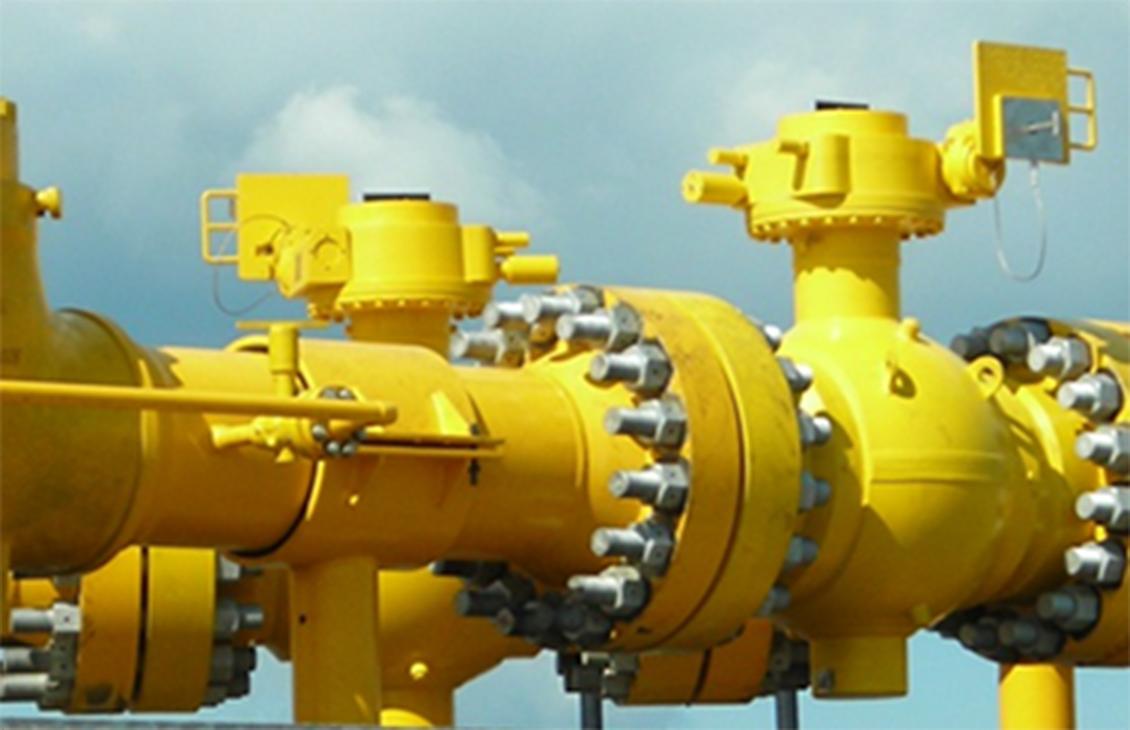Yellow subsea valves against a blue sky.